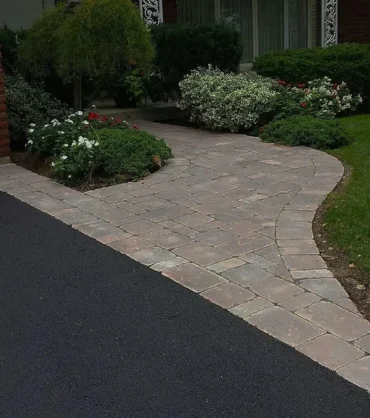 Well-maintained home and property by Artisan Outdoor Contractors LLC – landscaped yard, asphalt driveway, and walkway in Hunterdon County, NJ.